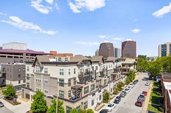 A street view of a residential area with cars parked on the side of the road. at Mirabelle Luxury Apartments, Kansas City, MO, 64111